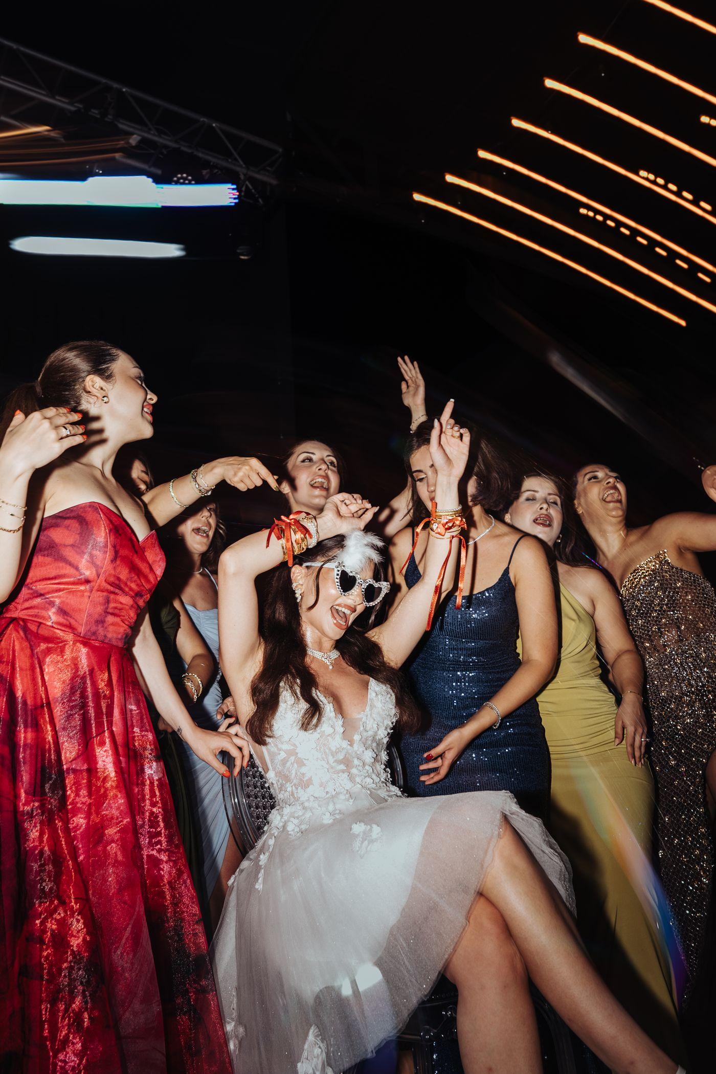 Guests dancing together at a night celebration.