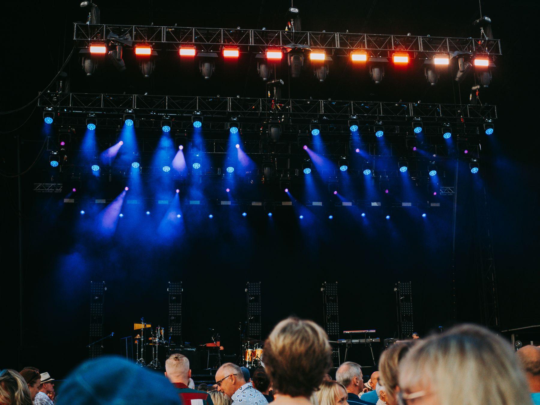 A lighting rig over an audience at an evening event.