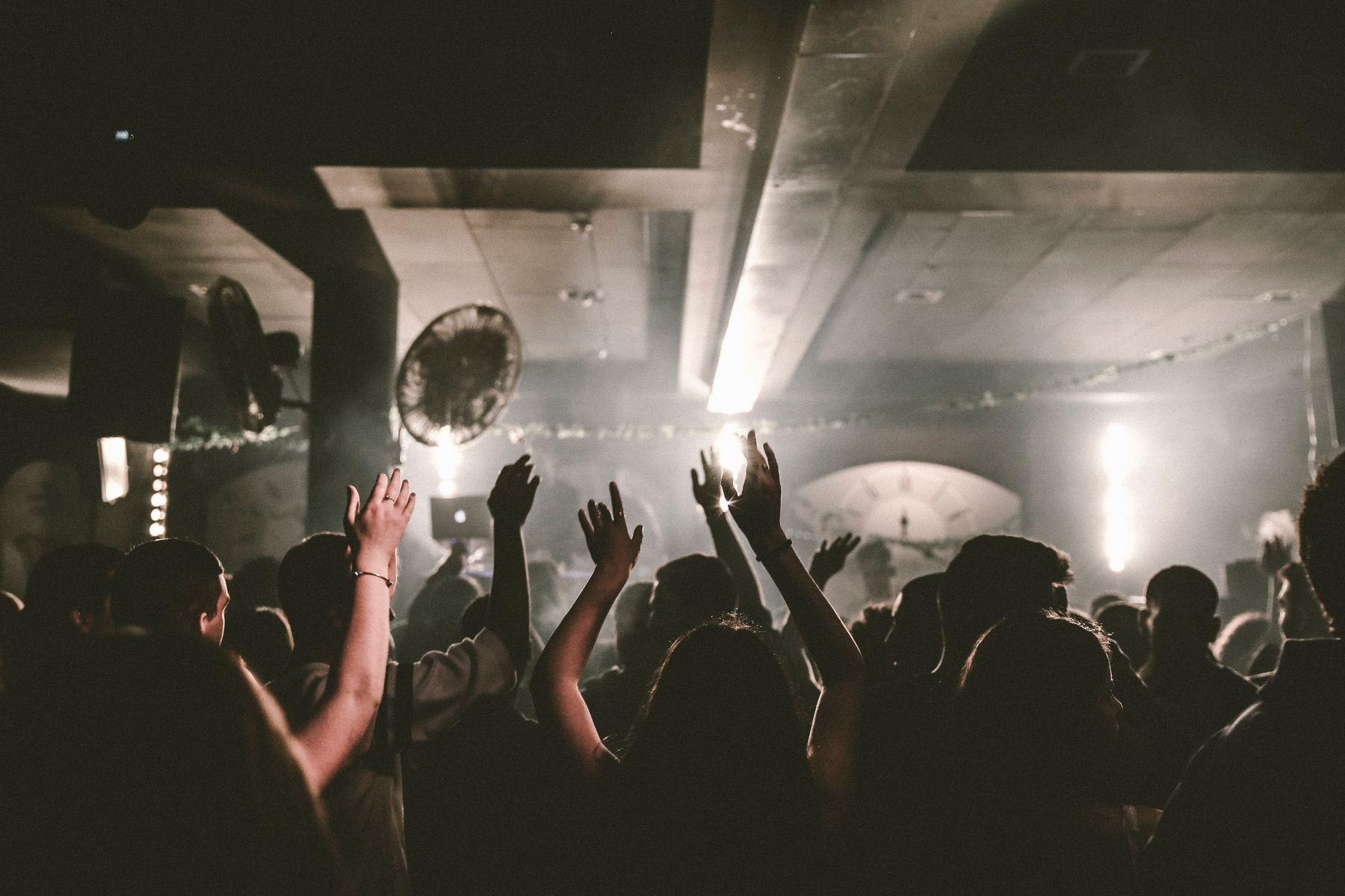 A crowded club floor under warm spotlights.
